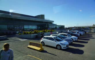 Cars are parked outside of Keflavik Aiport in Iceland.