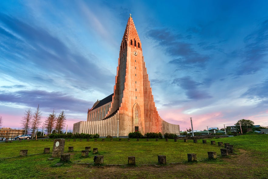 Hallgrimskirkja church in Reykjavik glowing at sunset, showcasing its towering modernist design