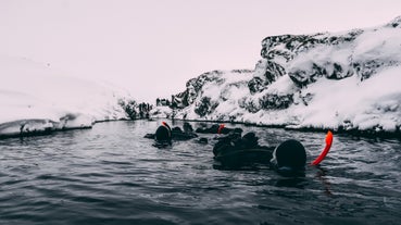 Silfra is a fissure in Iceland between two tectonic plates, filled with clear glacial water that offers exceptional visibility for divers and snorkelers.
