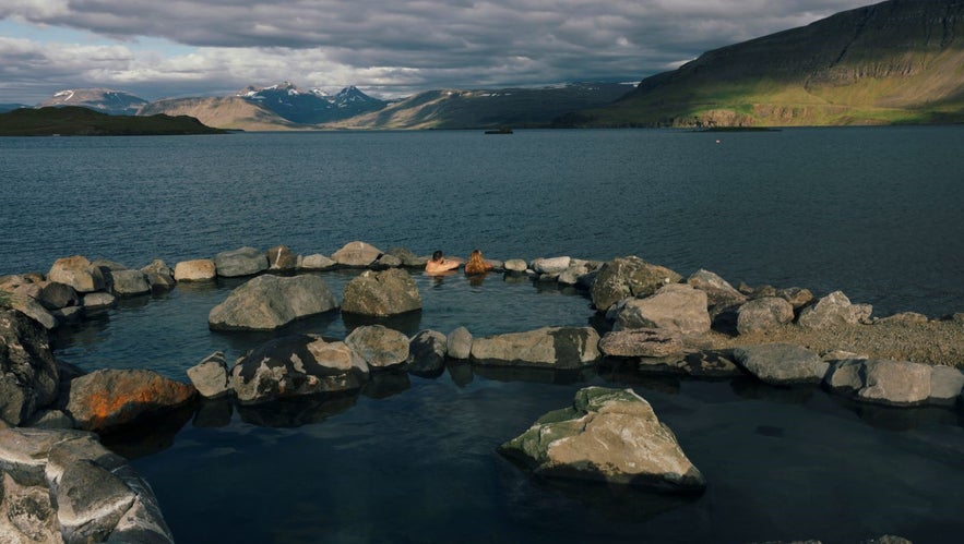 Couple at the Hvammsvik Hot Springs in Iceland enjoying the view