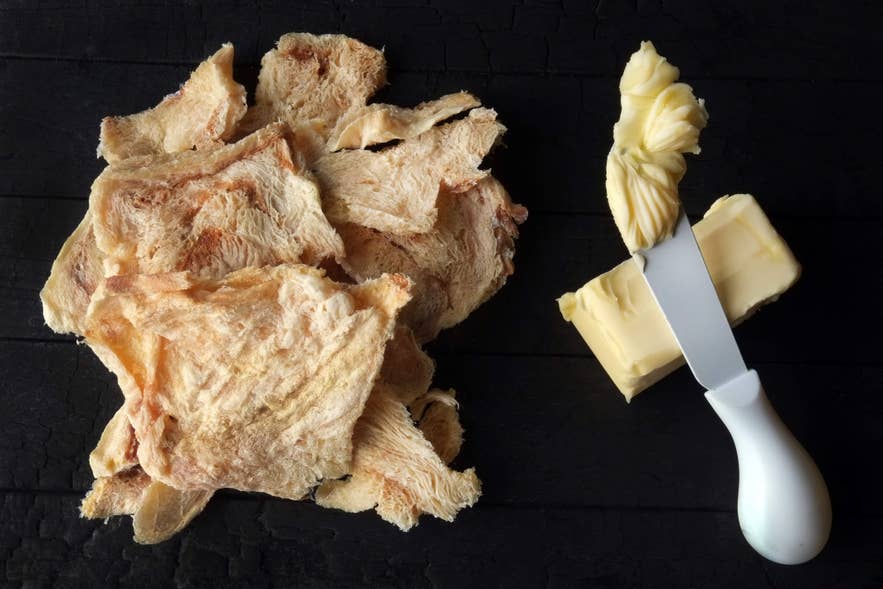 Hardfiskur dried fish with butter, a traditional Icelandic snack and one of the unusual foods often featured in Icelandic cuisine.