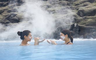 Two women relaxing in the Blue Lagoon’s hot geothermal water.