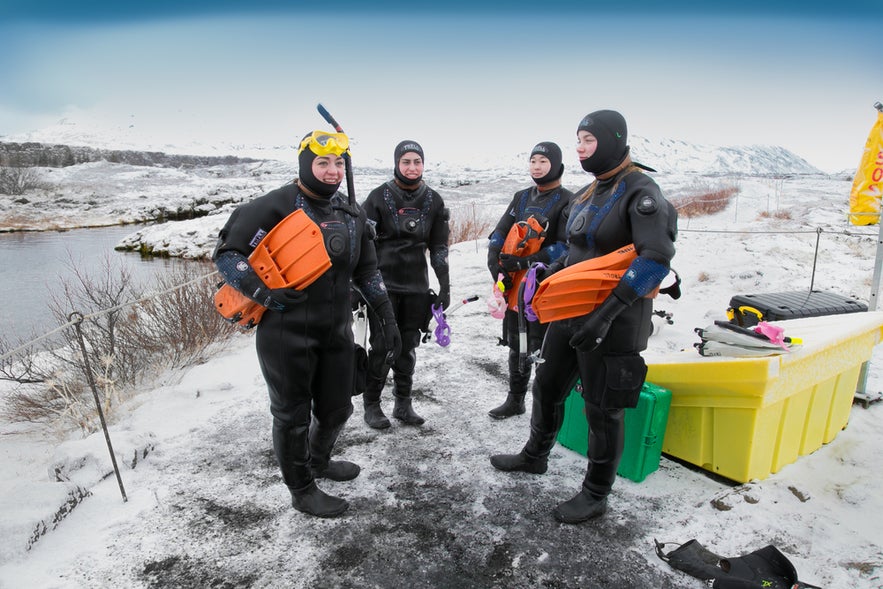 Group of divers in dry suits preparing for a Silfra Fissure tour in Thingvellir National Park, Iceland.