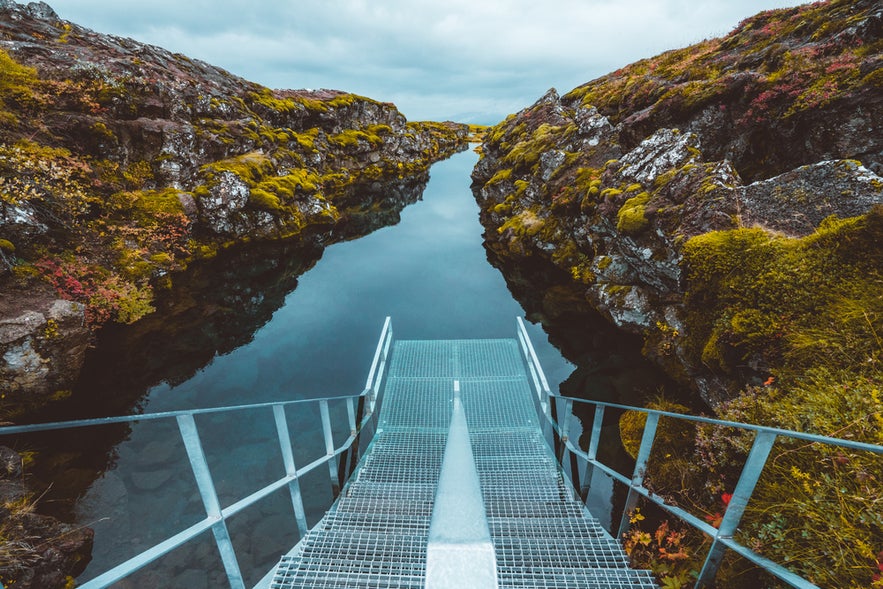 Silfra entry platform leading into the crystal-clear waters of the Silfra Fissure in Thingvellir National Park, Iceland.