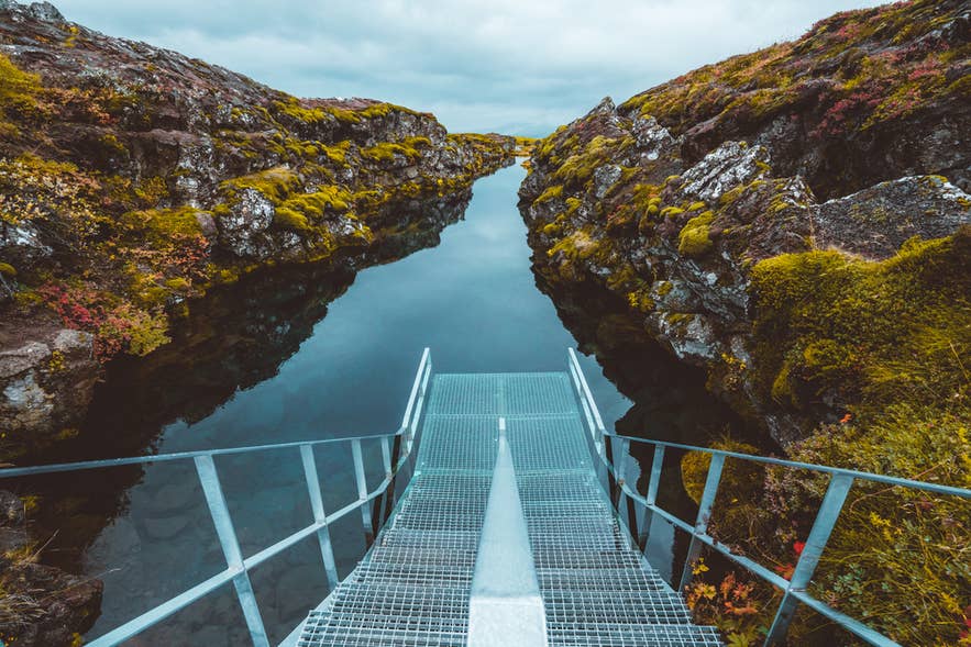 Silfra entry platform leading into the crystal-clear waters of the Silfra Fissure in Thingvellir National Park, Iceland.