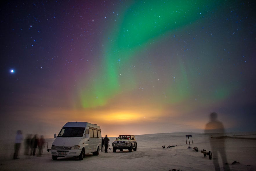Northern lights tour with one of the tour companies in Iceland featuring snowy landscapes and night sky viewing.