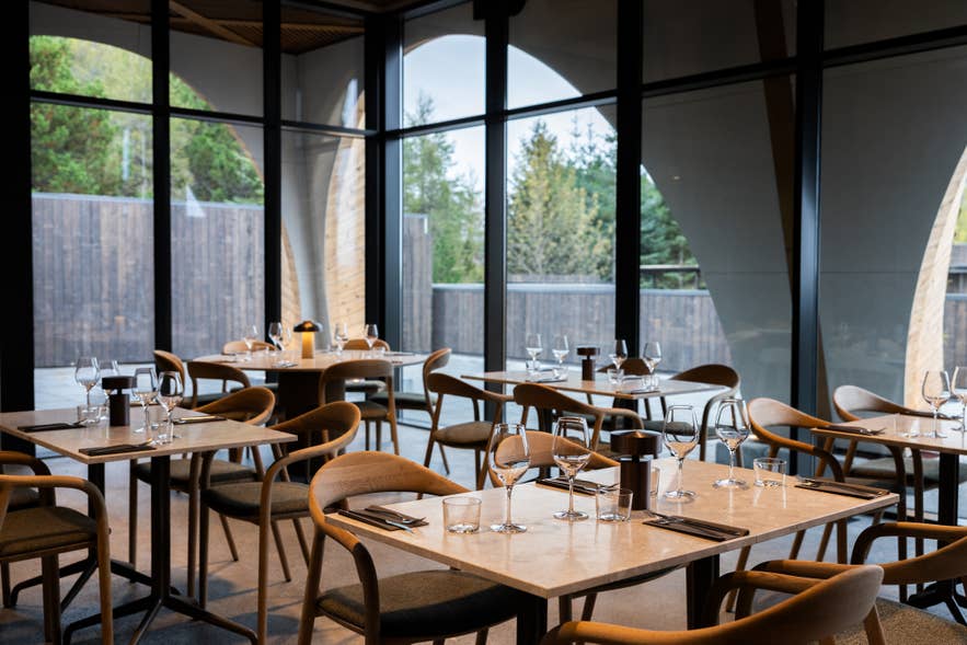 Ylja Restaurant with glass walls and forest views at Laugarás Lagoon, Golden Circle