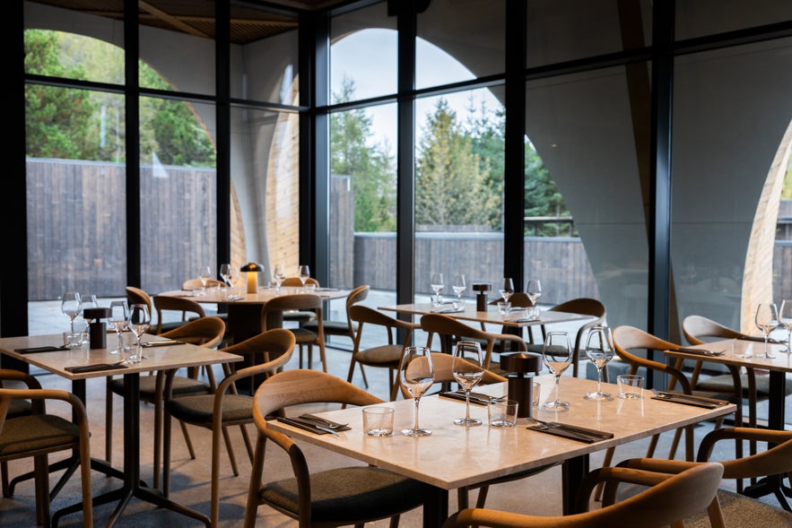 Ylja Restaurant with glass walls and forest views at Laugarás Lagoon, Golden Circle
