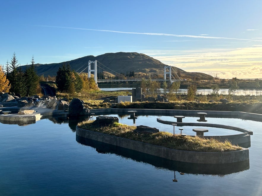 Geothermal pools and White River Bridge under blue skies at Laugarás Lagoon, Golden Circle Iceland Geothermal pools and White River Bridge under blue skies at Laugarás Lagoon, Golden Circle Iceland