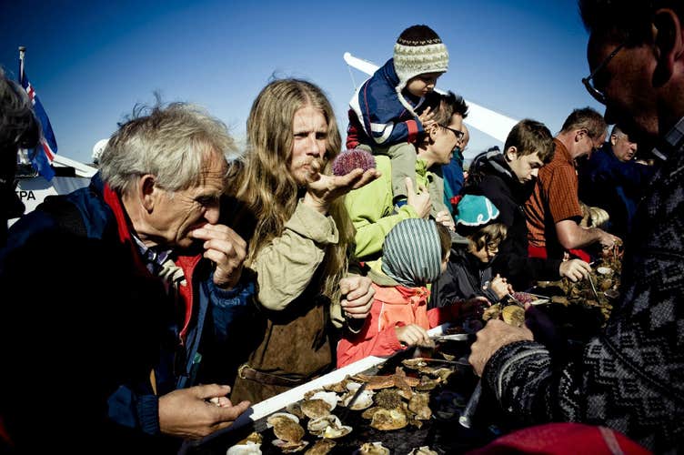 A group of cruise joiners enjoying their taste of seafood in Iceland's Breidafjordur bay.