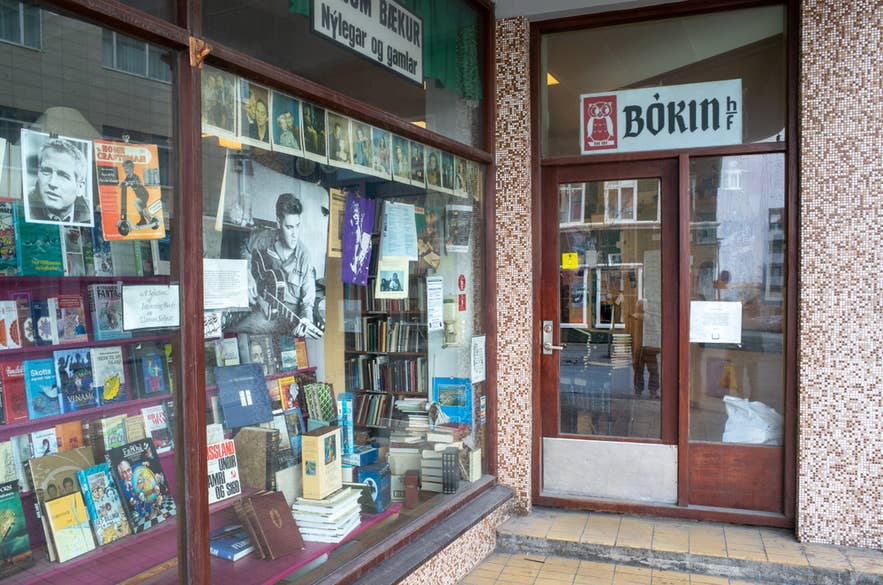 The book-filled window of Bókin, a beloved secondhand bookshop in Reykjavík, reflecting Iceland's love of reading.