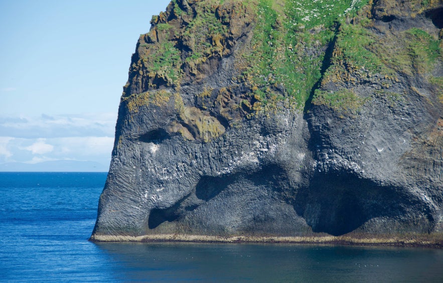 Elephant Rock on Heimaey Island, Iceland, a basalt sea cliff resembling an elephant dipping its trunk into the Atlantic Ocean.