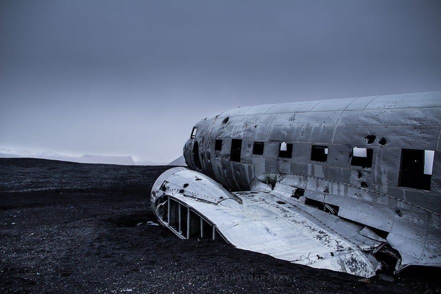 Close-up of the abandoned DC-3 plane wreck on Sólheimasandur black sand beach in South Iceland under a moody sky