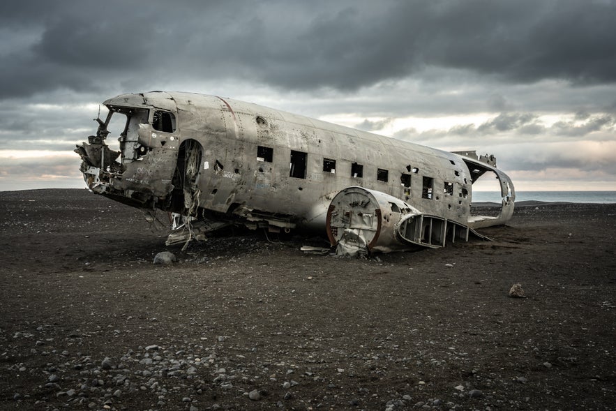 The DC3 Plane Wreck rests on the ground at Solheimasandur, surrounded by a barren, dramatic Icelandic landscape.