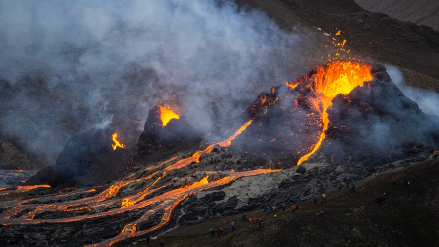 Lava erupts from Fagradalsfjall Volcano with glowing streams and smoke, showcasing the fiery natural wonders of Iceland