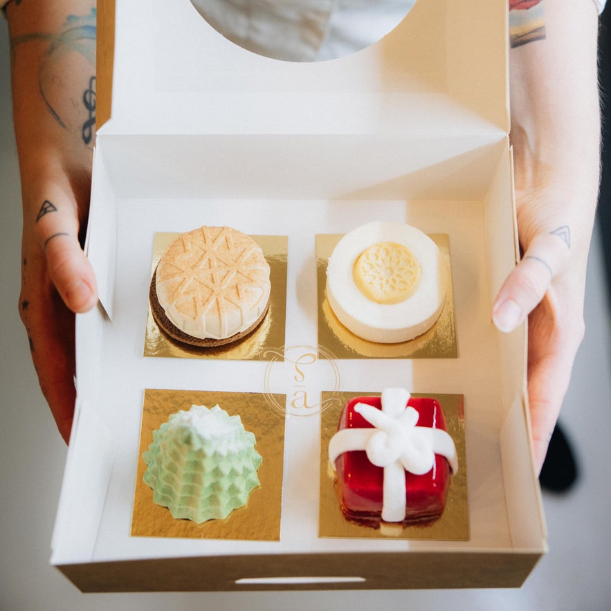 Box of elegant artisan pastries from Sweet Aurora patisserie in Reykjav&iacute;k, Iceland, featuring colorful modern desserts