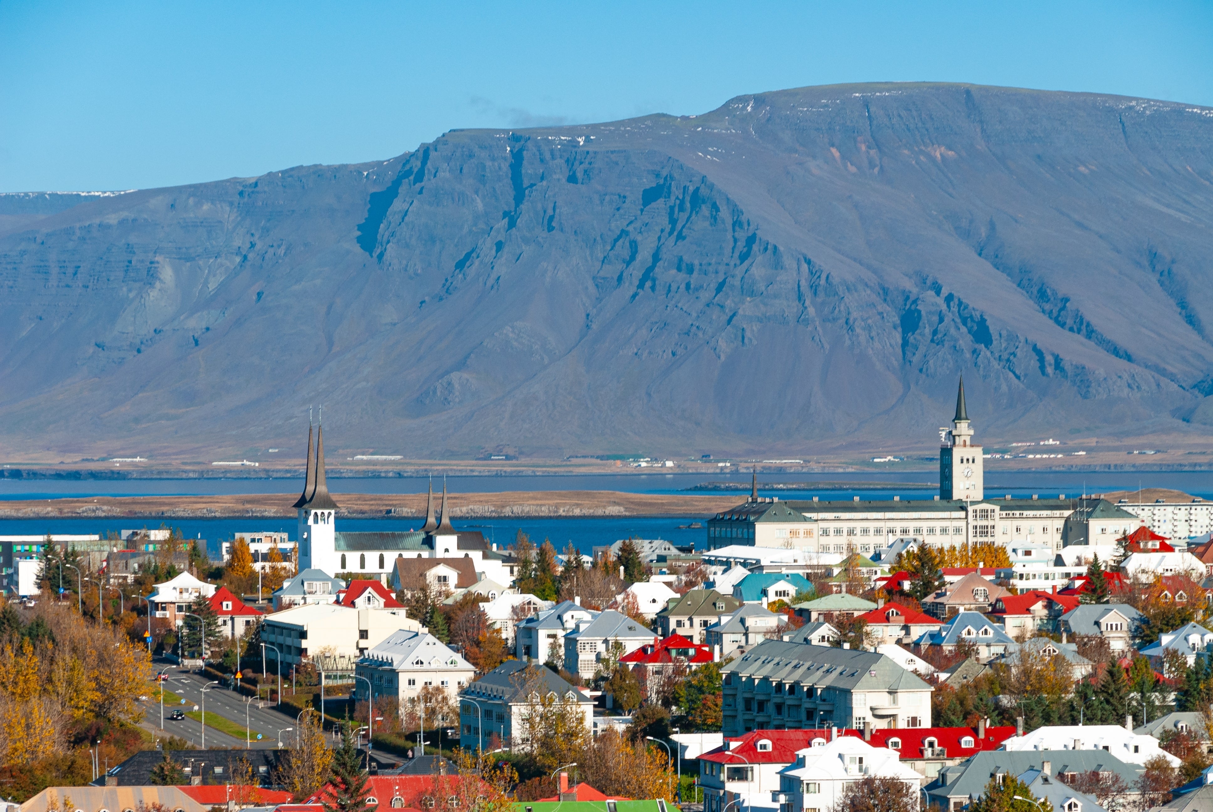 Colorful houses in Reykjavik with Mount Esja rising in the background.