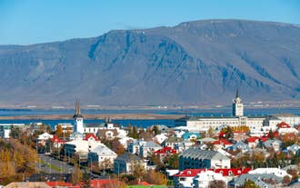 Colorful houses in Reykjavik with Mount Esja rising in the background.