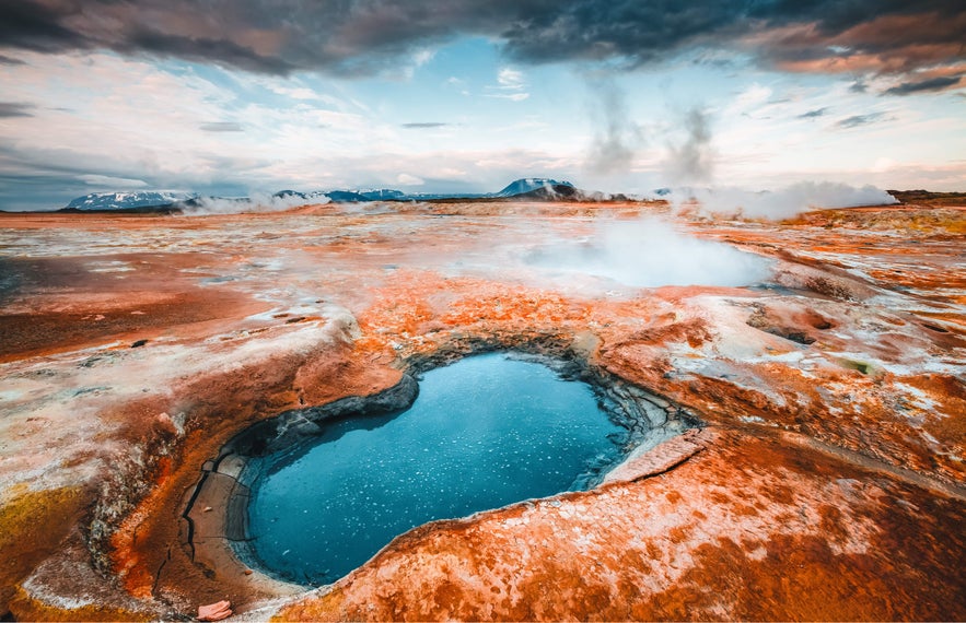 Boiling mud pool and steam vents at Namafjall Geothermal Area in North Iceland.