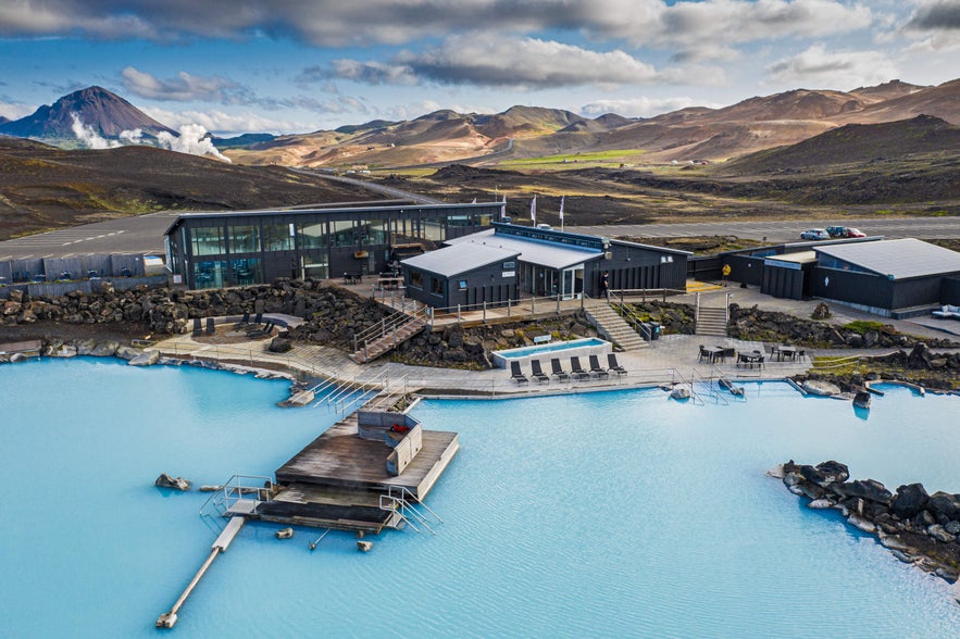 Aerial view of Earth Lagoon Mývatn geothermal spa in North Iceland with turquoise pools and volcanic mountain scenery.
