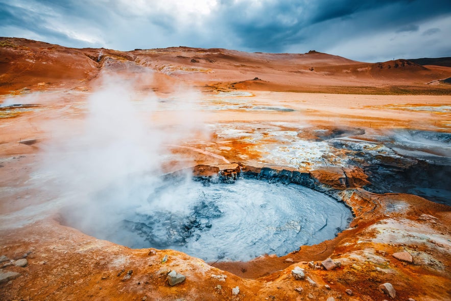Boiling mud pot and steam rising from the Namafjall Geothermal Area in North Iceland.