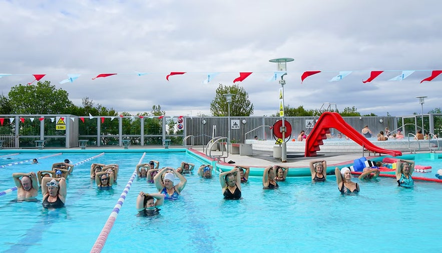 People participating in a water exercise class at Vesturbaejarlaug, one of Reykjavik’s geothermal swimming pools.