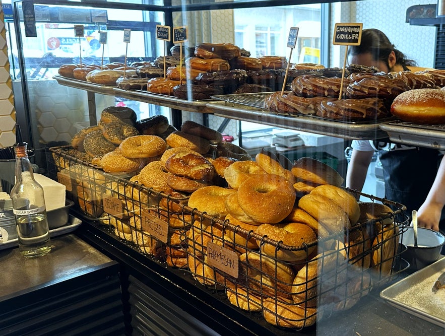 Fresh bagels, pastries, and cinnamon rolls on display at Deig Bakery inside the Exeter Hotel in Reykjavík, Iceland