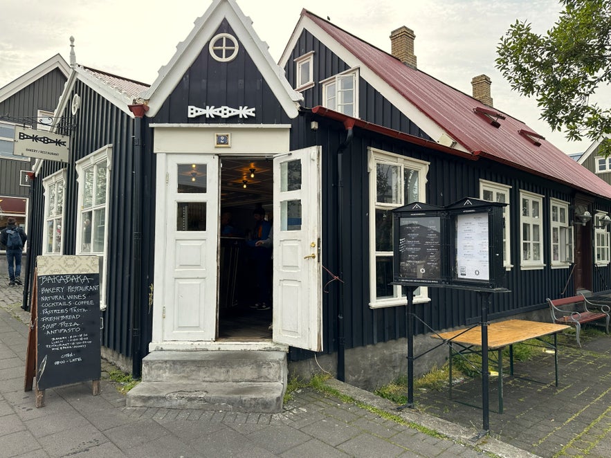 Exterior of Baka Baka bakery and restaurant in Reykjav&iacute;k, Iceland, housed in a charming black timber building