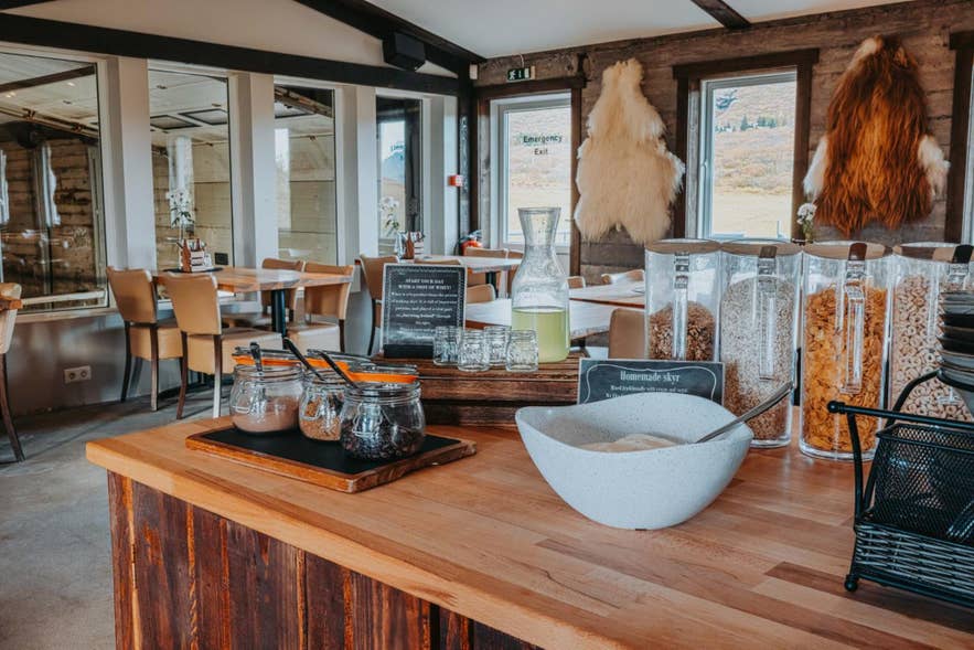 Inside Efstidalur Restaurant, a wooden counter displays a bowl of cereal, highlighting the warm, family-friendly dining experience.