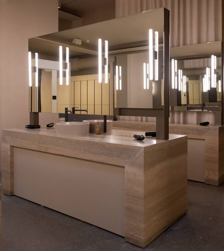 Elegant vanity station with mirrors and soft lighting inside the changing rooms at Laugarás Lagoon in Iceland Elegant vanity station with mirrors and soft lighting inside the changing rooms at Laugarás Lagoon in Iceland