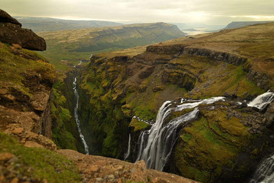 Wide view of Glymur Waterfall cascading into a narrow gorge in Hvalfjordur.