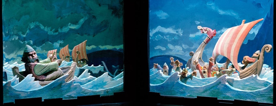 Colorful Viking ship display at a museum in Iceland showing Norse sailors on the open sea.