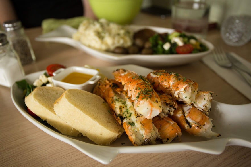 Plate of Icelandic seafood with bread and butter, a popular meal to try during your February in Iceland trip