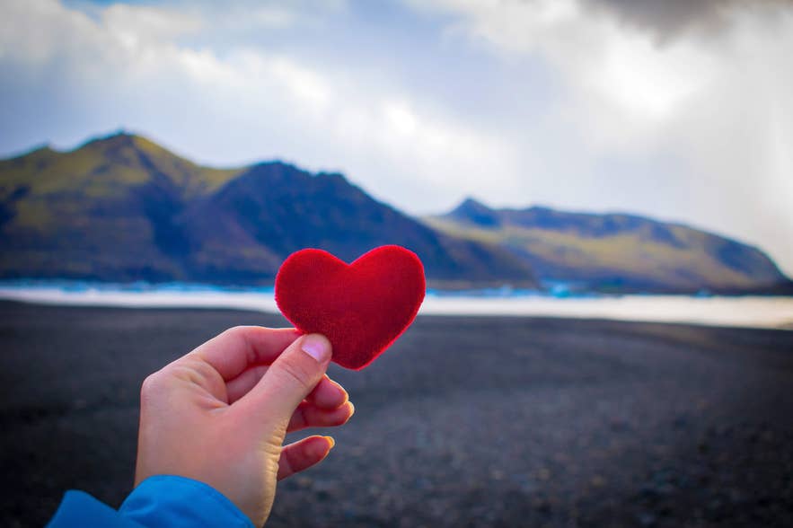 มือถือหัวใจสีแดงในอุทยานแห่งชาติวัทนาโจกุล (Vatnajokull National Park) ในไอซ์แลนด์เดือนกุมภาพันธ์