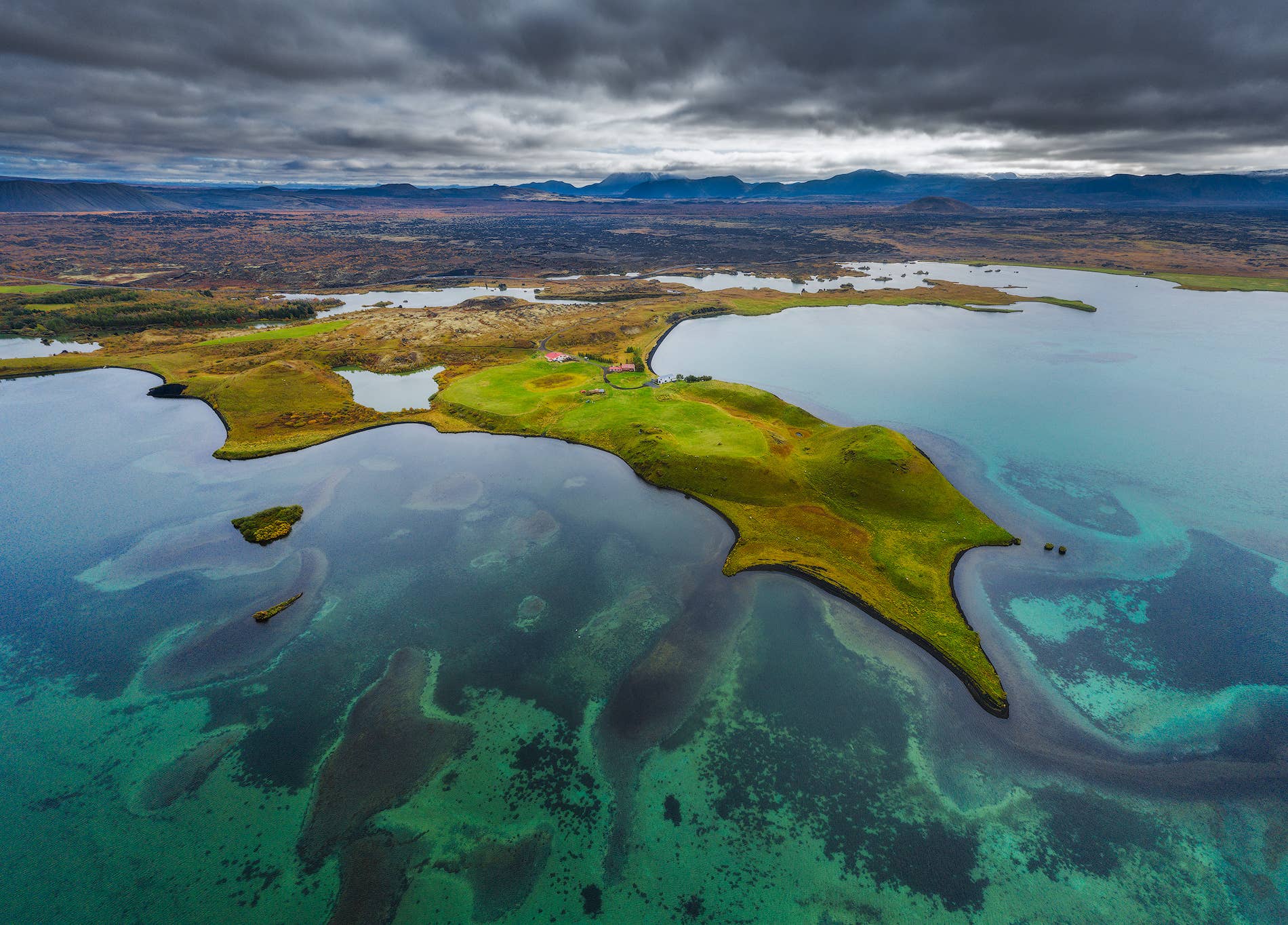 Aerial view of green shores and clear water at Lake Myvatn.