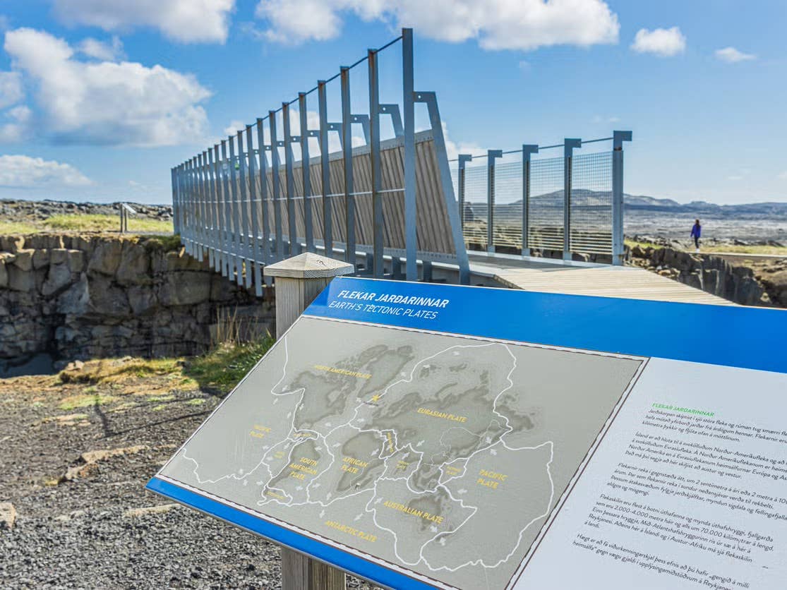 An information board waits at the mouth of the Bridge Between Continents, a stop on many Reykjanes tours in Iceland.