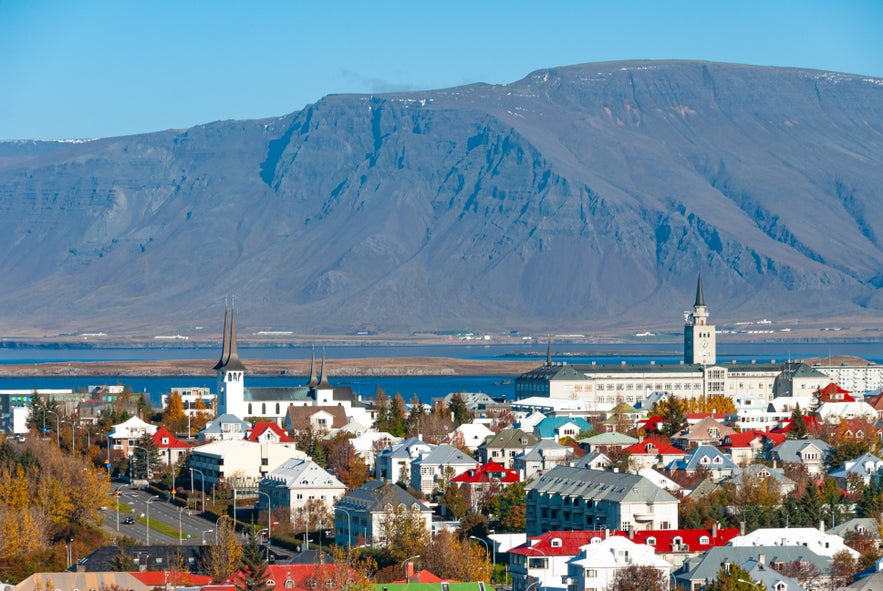Reykjavik skyline in summer with clear skies and distant mountains.