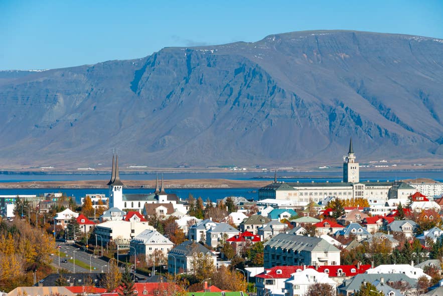 Reykjavik skyline in summer with clear skies and distant mountains.