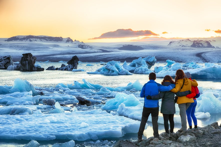A tour group enjoying Jokulsarlon glacier lagoon on a vacation package in Iceland.