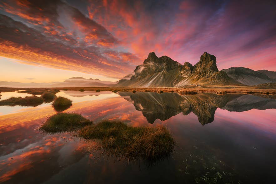 Iceland summer landscape at sunset with mountains and warm golden light.