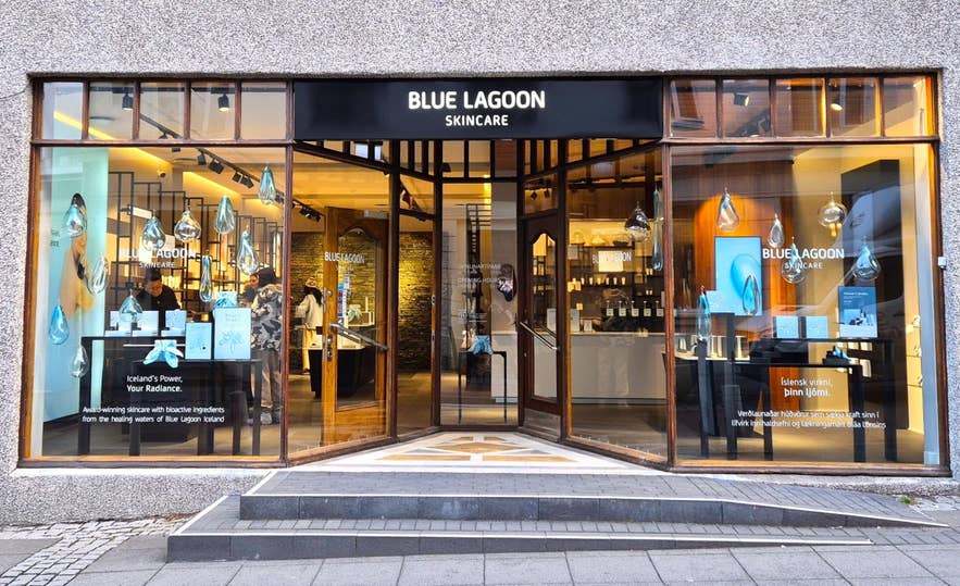 Exterior of the Blue Lagoon Skincare store on Laugavegur in Reykjavik, Iceland, with large glass windows and product displays.