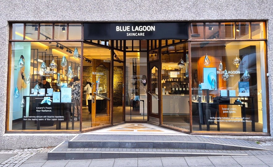 Exterior of the Blue Lagoon Skincare store on Laugavegur in Reykjavik, Iceland, with large glass windows and product displays.