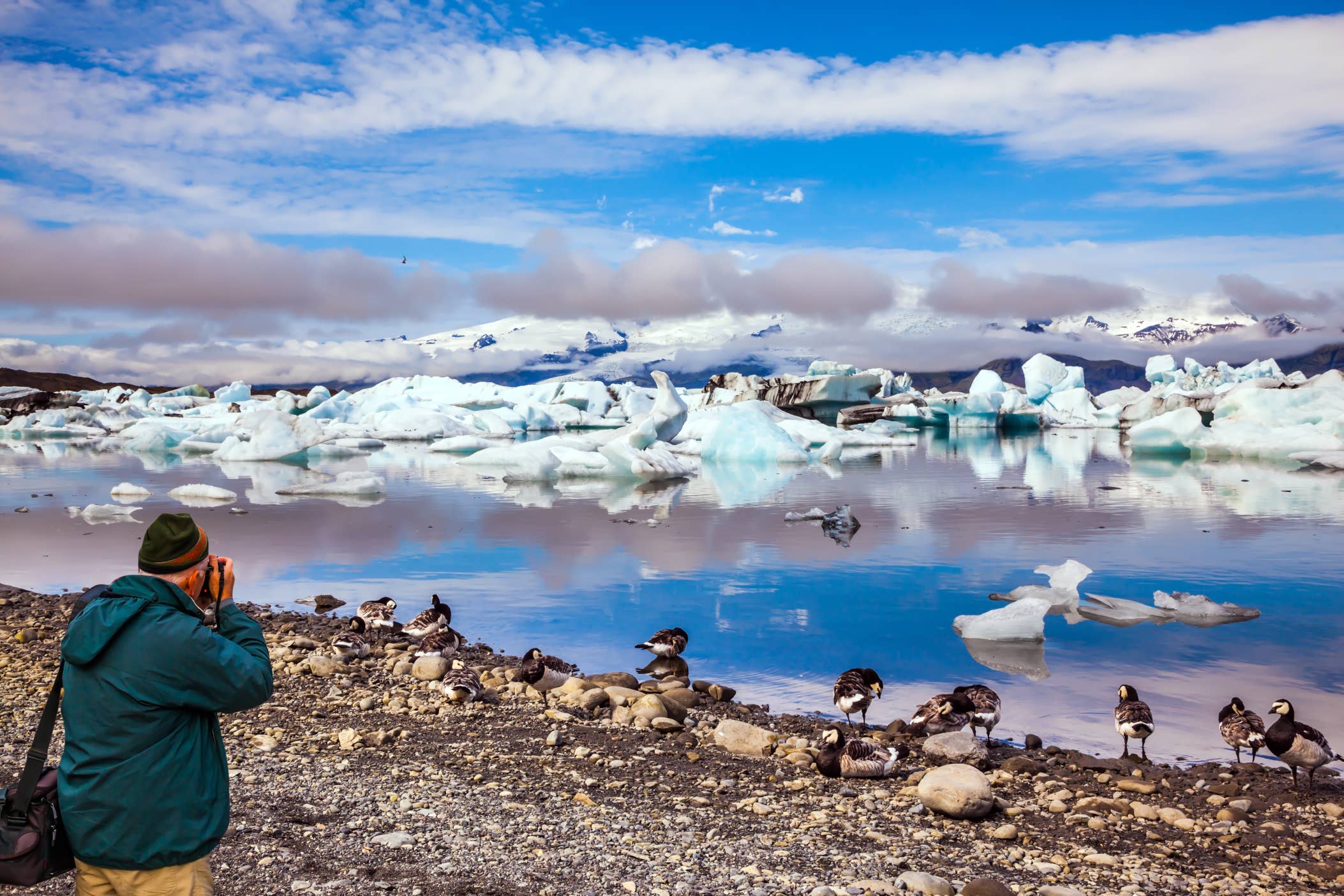 Jokulsarlon Glacier Lagoon with floating icebergs under a bright blue sky.