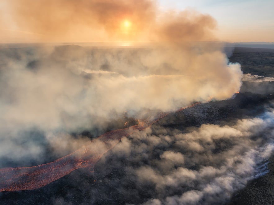 Aerial view of lava flow and volcanic gas clouds during the 2023 Litli-Hrutur eruption at sunset