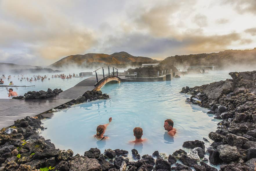 Visitors relaxing in the warm milky-blue geothermal waters of the Blue Lagoon in Iceland.
