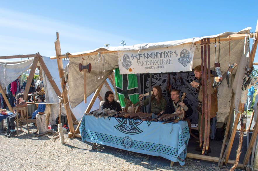 Group of people seated at a tent during the Viking Festival in Hafnarfjordur, Iceland.