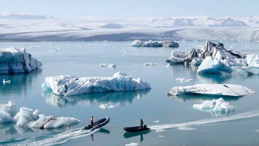 People on boats at the Jokulsarlon glacial lagoon