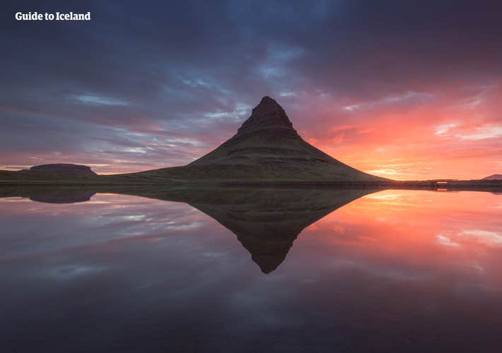 Kirkjufell's majestic form mirrored in the serene waters, a picture-perfect moment capturing the essence of Iceland's natural beauty.