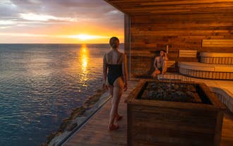 Visitors relaxing in the sauna at Sky Lagoon, Reykjavik, Iceland, overlooking the North Atlantic Ocean..