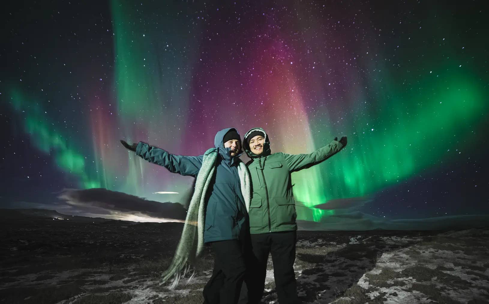Aurora borealis lighting up the sky during a winter northern lights tour in Iceland.